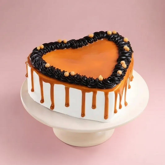Heart-shaped cake with black and orange icing on a white stand against a yellow background
